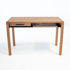 a wooden desk with a drawer on the bottom and an open drawer at the top