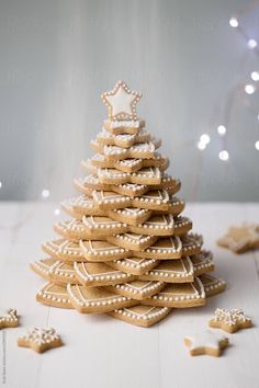 a christmas tree made out of cookies on a white table by julia lu for stocksy photography