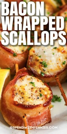 bacon wrapped scallops on a plate with lemon wedges