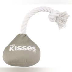 a white rope hanging from the side of a gray and white bag with kisses written on it