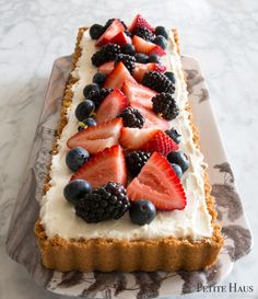 there is a cake that has fruit on it