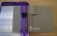 a purple and white binder sitting on top of a table next to a ruler