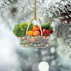 a christmas ornament hanging from a tree filled with fruit and vegetables