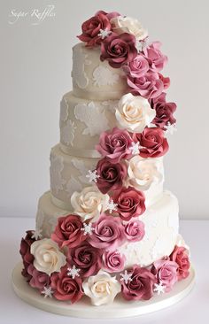 a wedding cake with pink and white flowers on it's tiers is displayed in an instagram