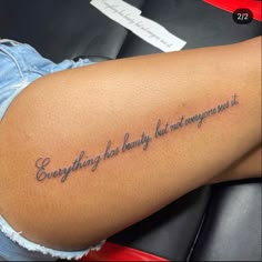 a woman with a tattoo on her thigh saying everything has beauty, but not even it