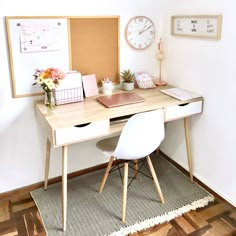 a desk with two chairs and a clock on the wall above it in a home office