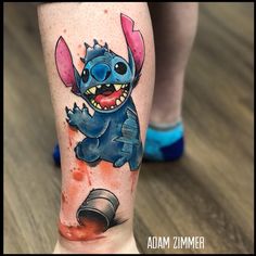 a person with a tattoo on their leg that has an image of stitcher from stitch