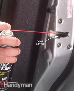 a person is opening the door latch on a car's side window with a red string