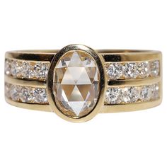 an image of a ring with diamonds on the bottom and gold tone bands around it