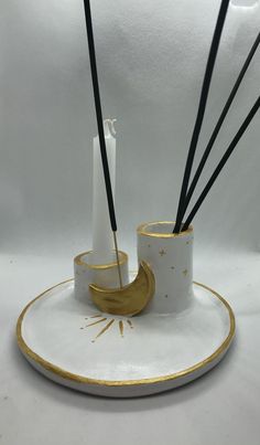 a white and gold plate with some candles on it