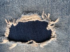 an old pair of jeans that has been ripped and is showing the holes in it