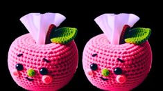 two pink knitted apples with faces on them