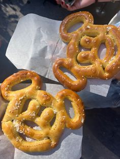 two pretzels sitting on top of wax paper