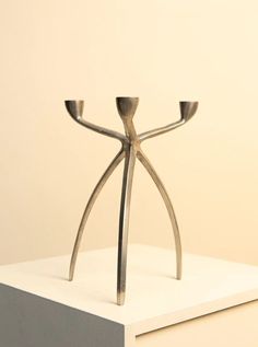 a metal sculpture sitting on top of a white table