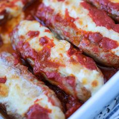 some meat covered in sauce and cheese in a casserole dish