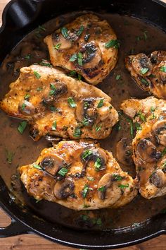 chicken with mushrooms in a skillet on a wooden table