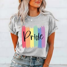 The "Pride Paint Strokes" Graphic Tee is more than just a garment; it's a vibrant celebration of diversity, love, and unity within the LGBTQ+ community. Crafted with meticulous attention to detail, this tee combines comfort with style, making it the perfect choice for expressing your pride and solidarity. The colorful rainbow paint strokes create a bold and eye-catching design, symbolizing the spectrum of identities and experiences within the LGBTQ+ community. Whether you're marching in a pride Cotton T-shirt With Rainbow Print For Pride, Trendy Multicolor Pride T-shirt, Trendy Rainbow Pride T-shirt, Trendy Rainbow T-shirt For Pride, Spring Graphic Tee With Rainbow Print, Trendy Rainbow Top For Pride, Spring Multicolor Slogan T-shirt, Pride Cotton Crew Neck T-shirt, Spring Multicolor T-shirt With Text Print