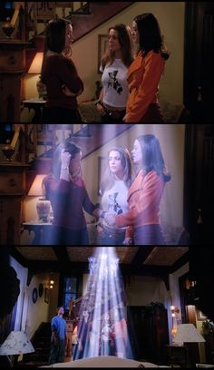 three girls standing in a living room talking to each other while the light shines from behind them