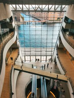 an escalator in the middle of a building with people walking up and down it