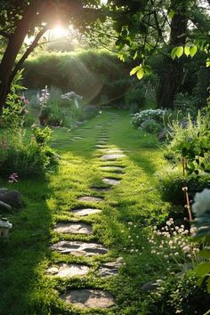 a stone path in the middle of a lush green yard with flowers and trees on either side