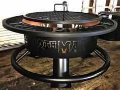 an outdoor fire pit sitting on top of a wooden floor