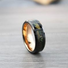 an image of a wedding ring with camo inlay