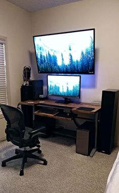 a computer desk with a monitor and speakers