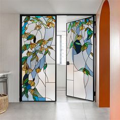 two glass doors with colorful leaves on them