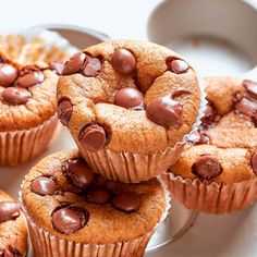 several chocolate chip muffins stacked on top of each other in front of a cupcake tin