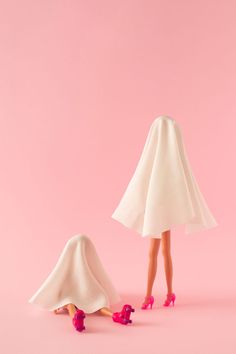 Girls in white ghost costume with rollers and high heels on pink background.. Creative halloween funny party concept. White Ghost Costume, Pink Costume, Ghost Costume