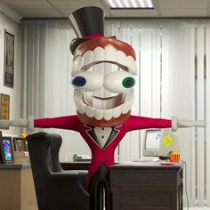 a large inflatable character sitting at a desk