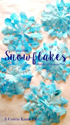 snowflakes made out of blue paper on a table