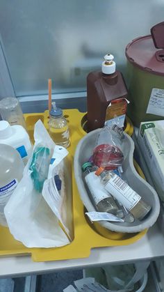 an assortment of hygiene products on a yellow tray