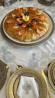 a table topped with plates and silverware covered in food