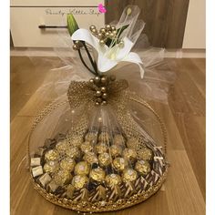 a basket filled with chocolates and flowers on top of a wooden floor