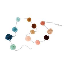 multicolored pom - pom garland on white background