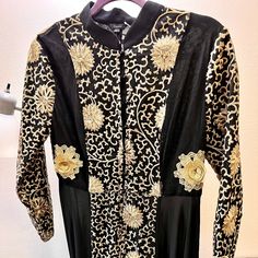 A Beautiful Black And Gold Abaya Dress With A Unique Mandarin Collar That Is Light And Easy To Wear. Its Beautiful Embroidery Is Very Attractive And Is Perfect For Any Dressy Or Elegant Occasions. It Is In Large Size But Runs Small With A Nice Fit To The Body. Black Abaya With Dabka Work For Eid, Elegant Long Sleeve Maxi Dress With Resham Embroidery, Anarkali Abaya For Eid Evening, Formal Embroidered Long Sleeve Maxi Dress, Embroidered Long Sleeve Maxi Dress For Formal Occasions, Formal Long Sleeve Embroidered Maxi Dress, Black Dress With Dabka Work For Eid, Black Long Sleeve Kaftan For Wedding, Anarkali Style Maxi Abaya For Parties