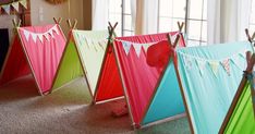 there are many different colored tents in the room