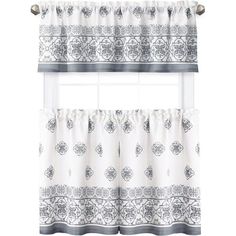 a window curtain with an ornate design on the top and bottom, hanging from a metal rod