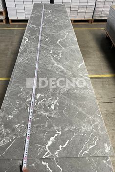 grey marble slab with measuring tape on top in warehouse setting stock photo idcnc097