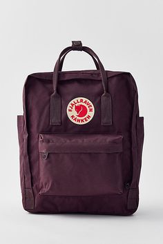 Lightweight coated canvas backpack from Fjallraven with a wraparound zip closure and an interior envelope pocket for toting your tablet. Topped with an additional zip pocket at the front and adjustable, webbed straps at the back. Double carry handles along the top. Content + Care PVA, polypropylene, mixed metal Spot clean Imported Size Dimensions: 10.62" l x 5.11" w x 14.96" h | Fjallraven Kånken Backpack in Dark Purple, Women's at Urban Outfitters Fjallraven Backpack, Pretty Tote Bags, Envelope Pocket, Backpack Design, Pinterest Contest, Purple Fits, Purple Backpack, Lightweight Backpack, Aesthetic Iphone