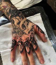 a person with tattoos on their hands and arms