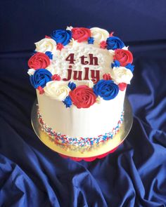 a white cake with red, white and blue frosting on it that says 4th july