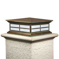 a light that is on top of a wall next to a lamp post with a skylight above it