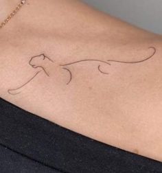 a woman with a cat tattoo on her back shoulder and neck, it looks like she's flying through the air