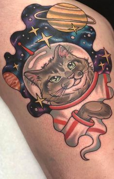 a cat in an astronaut's outfit with stars and planets around it on the thigh