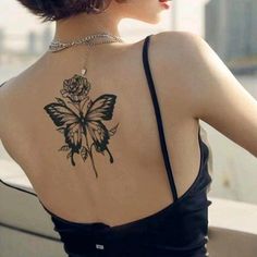 a woman with a butterfly tattoo on her back