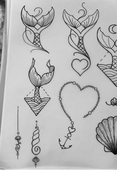 some tattoos are drawn on paper and have been placed in the shape of mermaids