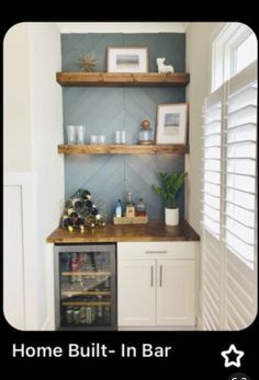 a small kitchen with built in bar and shelves