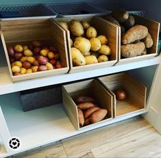 several bins filled with different types of fruit on top of a white book shelf